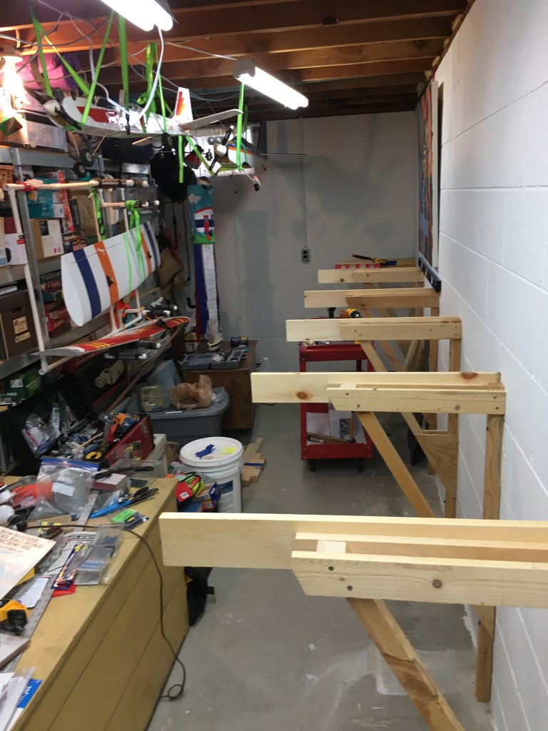 Wood, angle braces, tools, airplanes, white wall