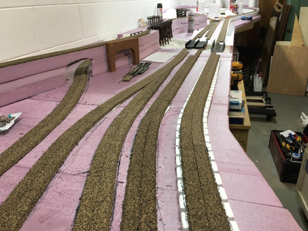 Cork roadbed glued in place on the pink extruded foam board.