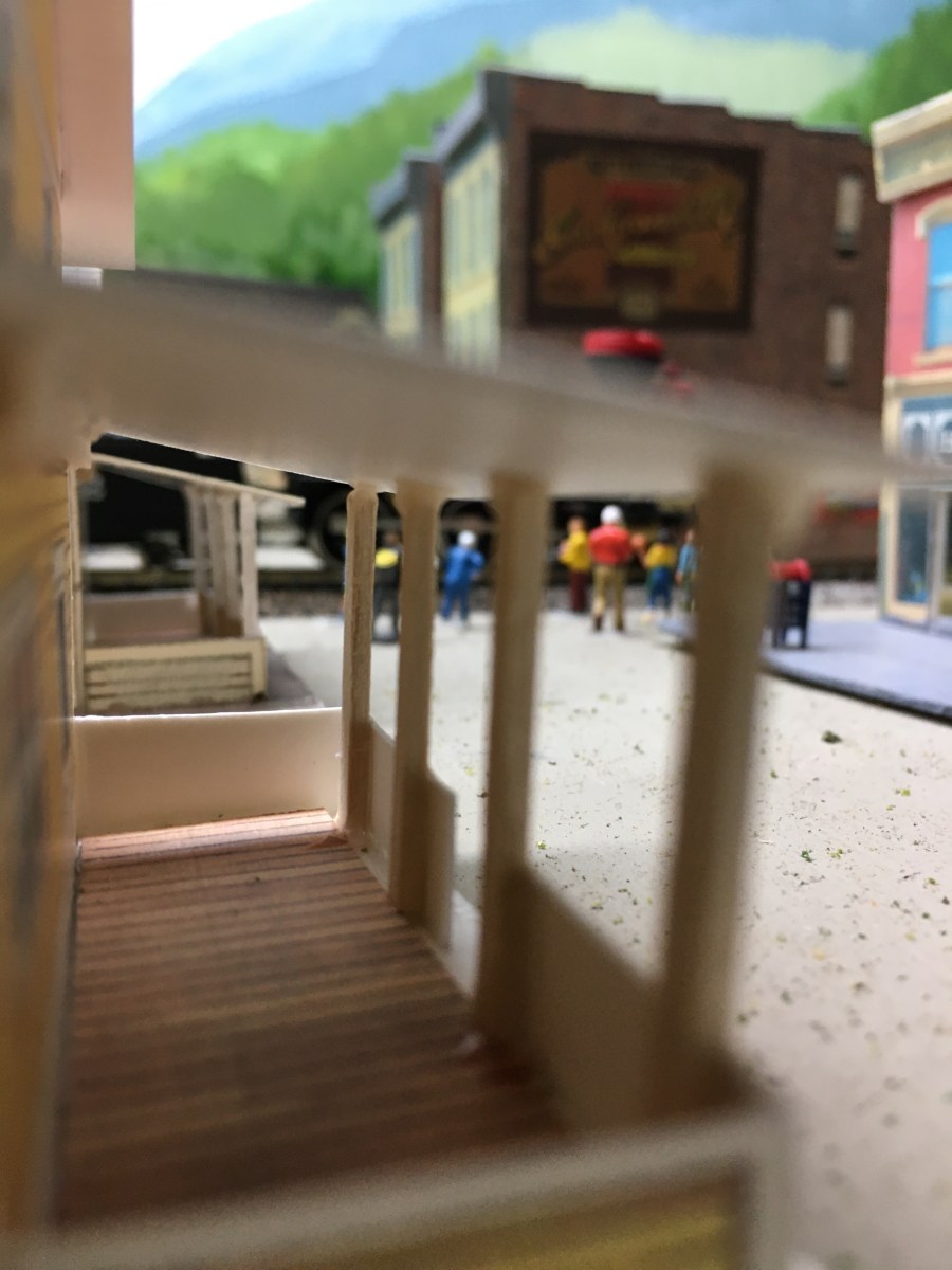 Porch view, street, buildings, people