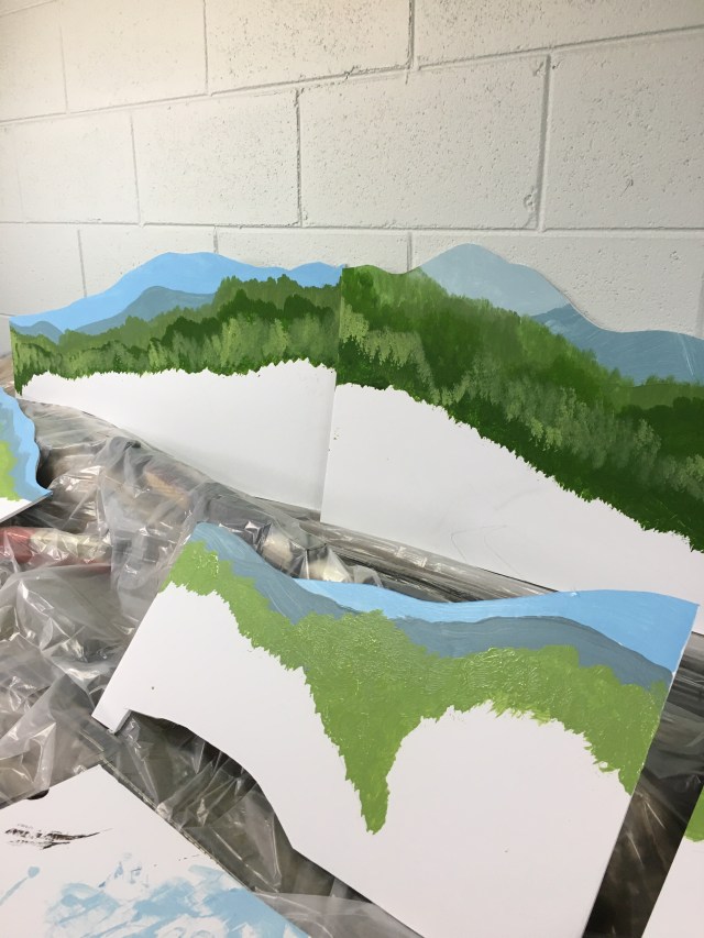 Uneven treetops indicate mountain range.