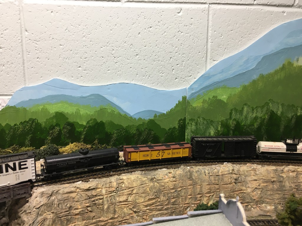 A freight train moves through the mountains.