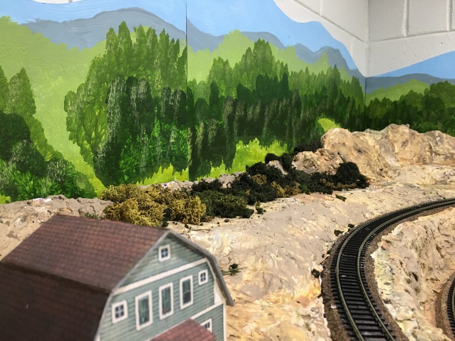 Curved track, building, painted backdrop, bushes