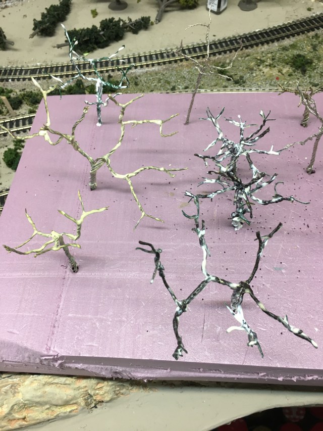 Several floral wire trees painted with latex mold material.