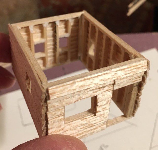HO scale cabin in balsa with studs, window frames, and siding.