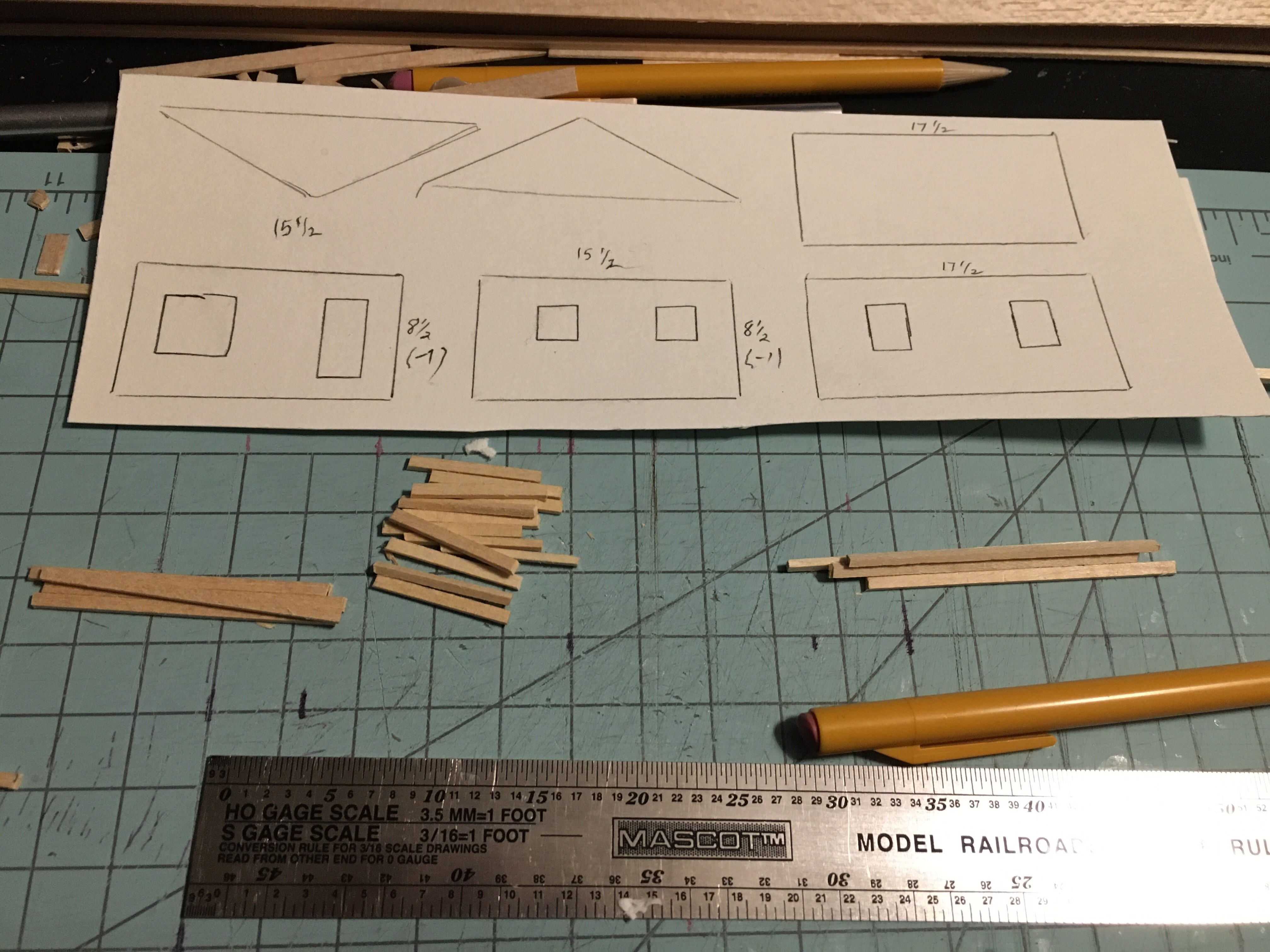 Four walls and two trusses drawn on cardstock in 1:87 scale.
