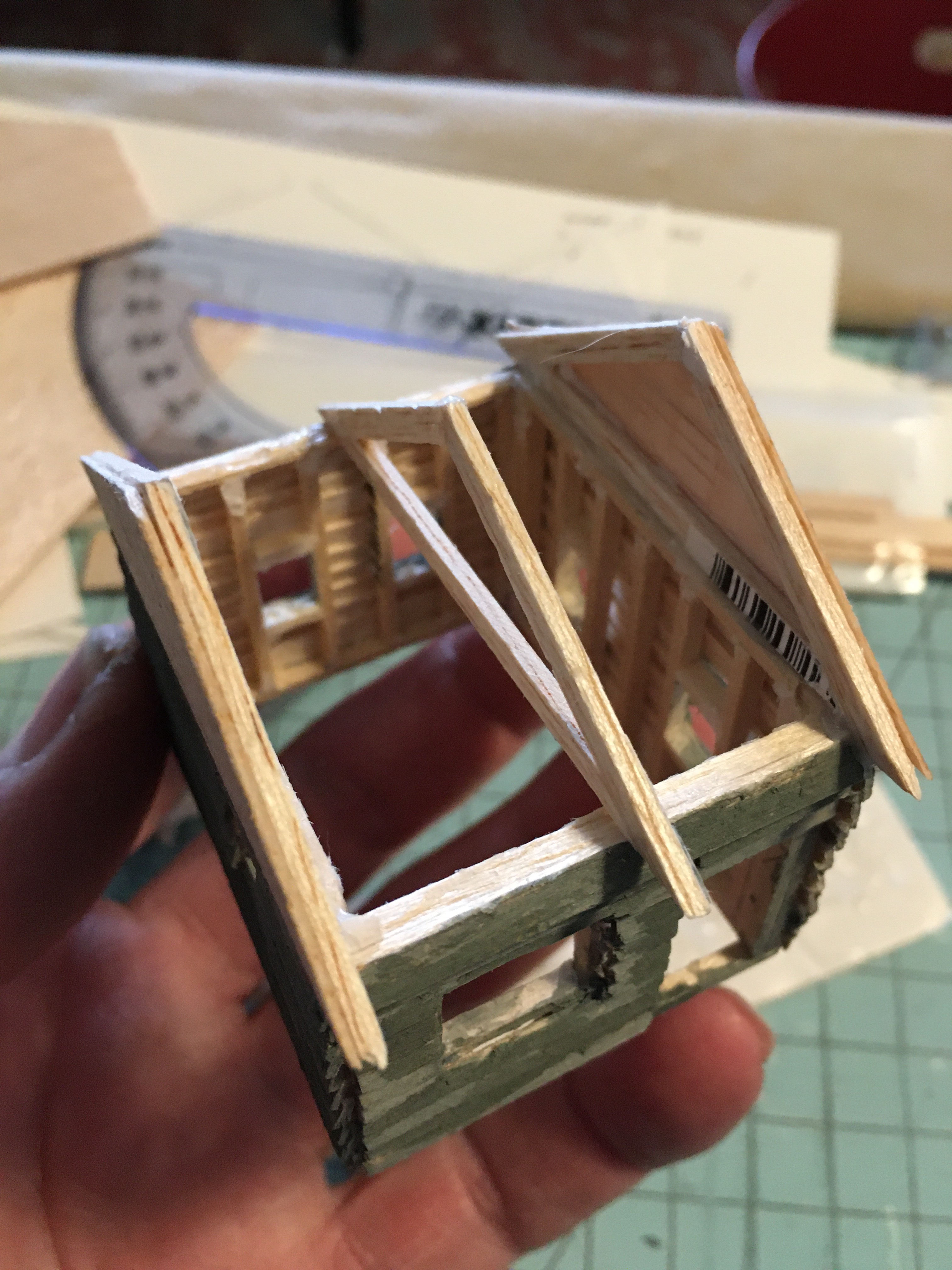 Overhead view of tiny balsa cabin with three roof trusses.