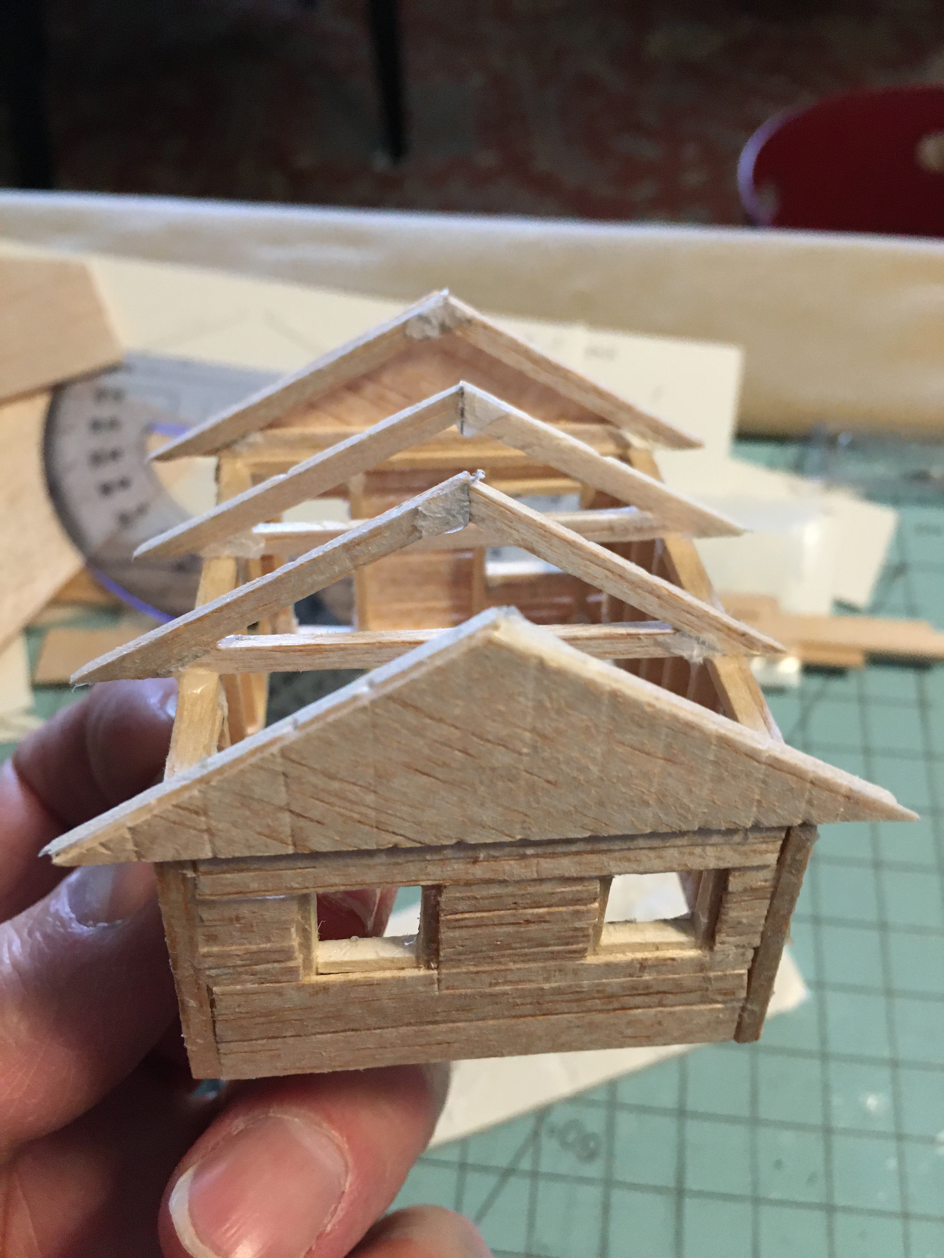 End view of cabin showing finished gable and trusses. Window frames show space for trim.