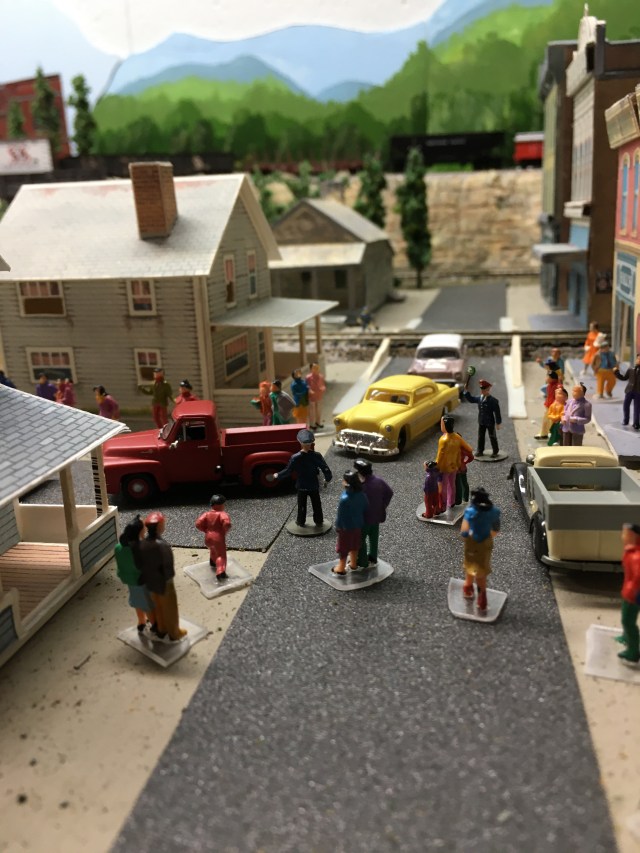 People on the street, cars, buildings