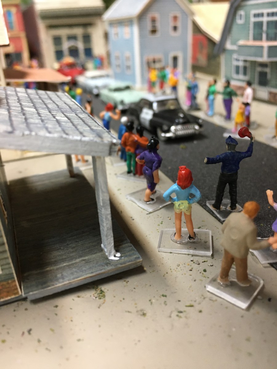 People, cars, houses, street