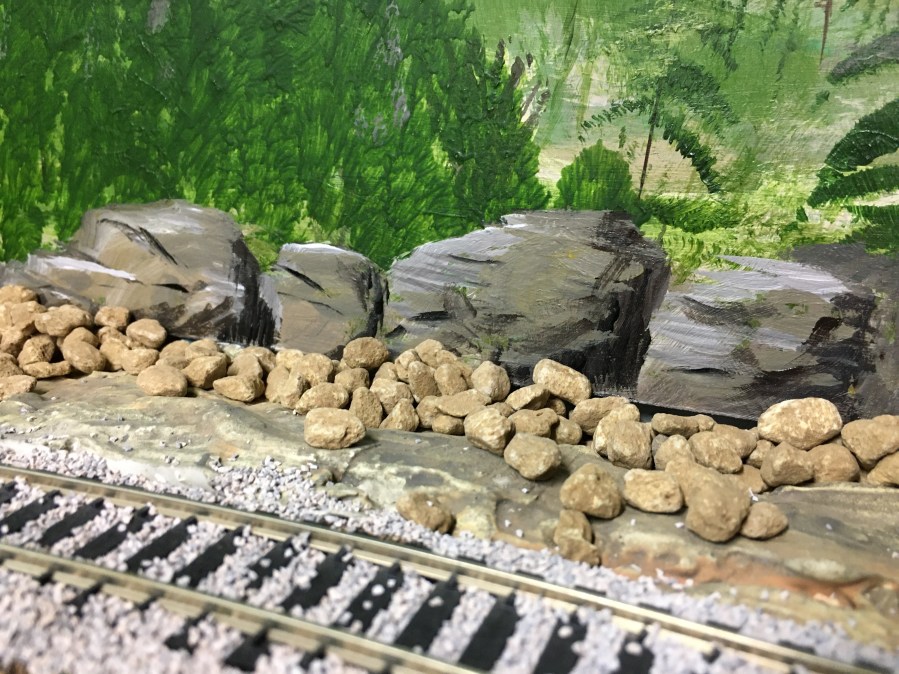 Acrylic painting of large rocks with shadowing for depth.
