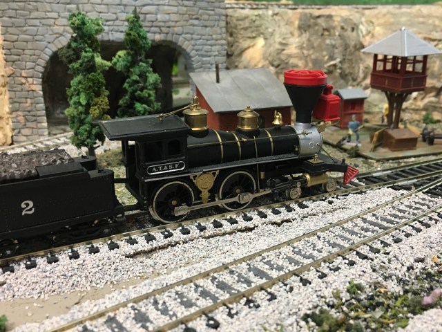 Civil War Era locomotive, trees, buildings, train track