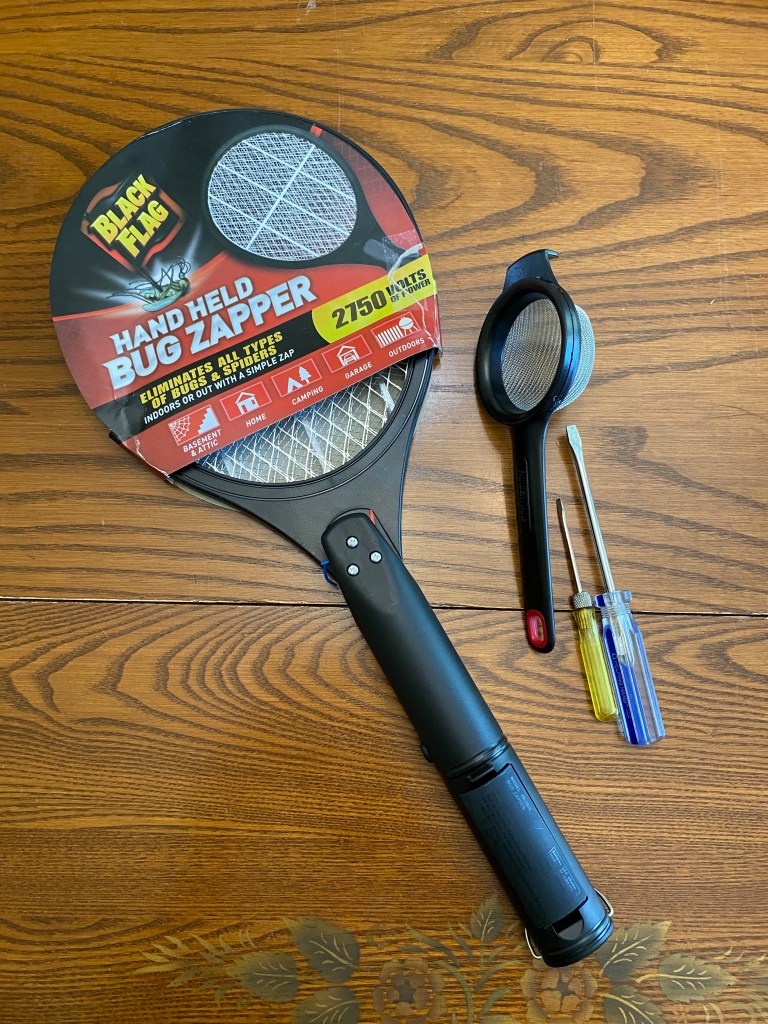 Black Flag electric bug zapper and small strainer.  These are the components of a homemade static grass applicator that really works.