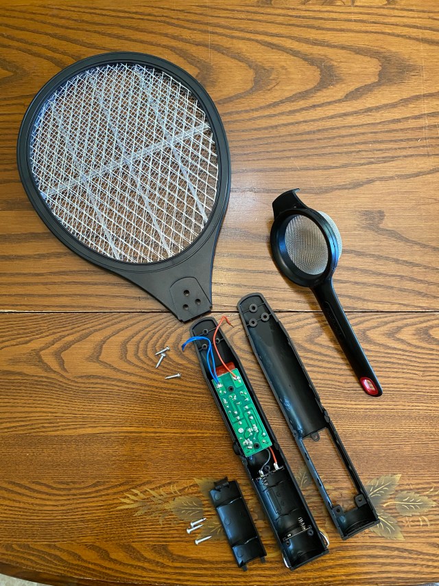 Separate pieces of bug zapper and small strainer.