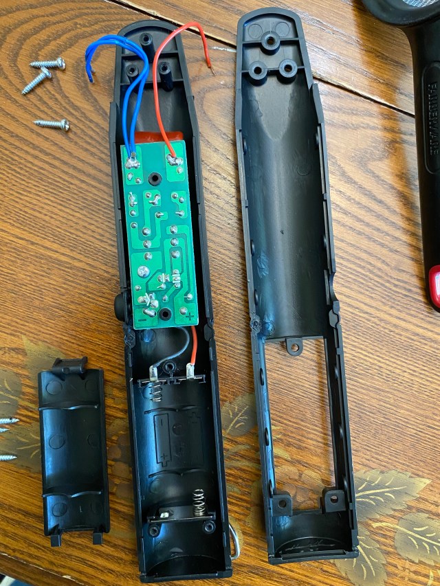 Bug zapper handle opened to show control board.