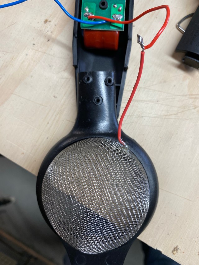 Hand strainer with holes drilled placed on screw posts in zapper handle. Red wire soldered to red wire from control board in the handle.