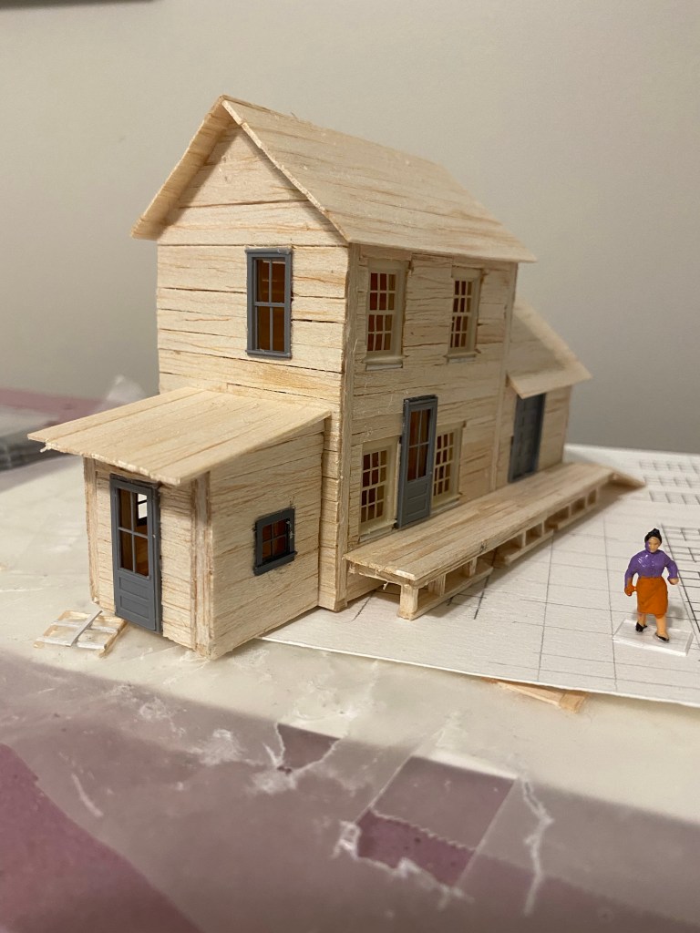 Front view from if two story balsa building with roof.