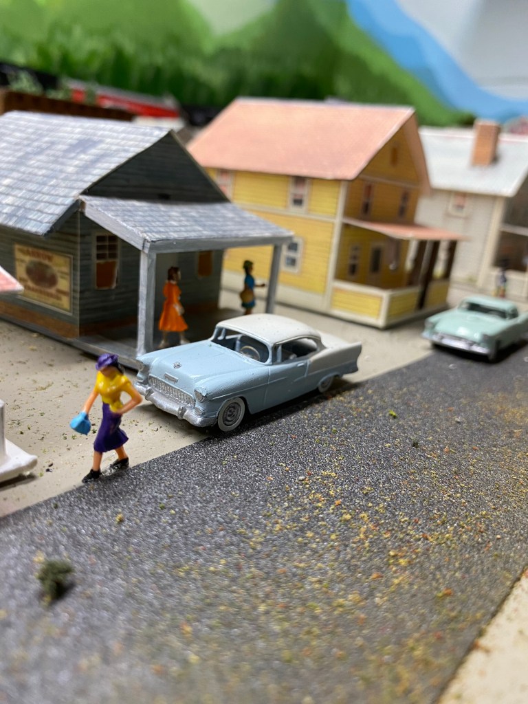 Maple Valley street scene with people, shops, and cars.
