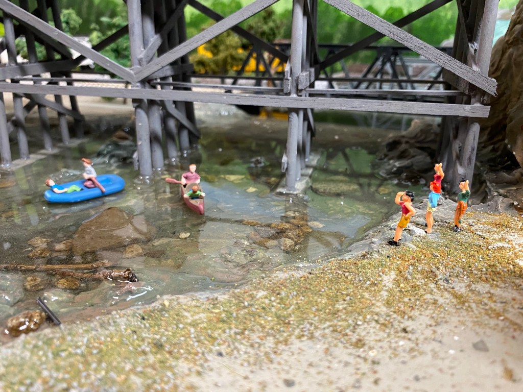 Maple Valley River with canoers and swimmers watching.