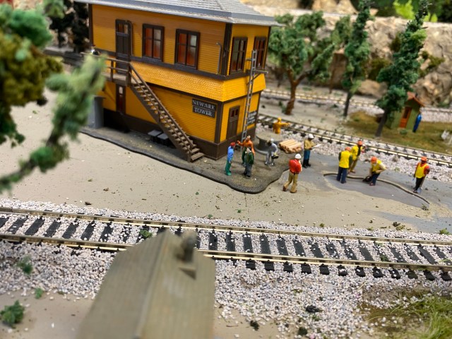 Several workers together near interlocking tower.