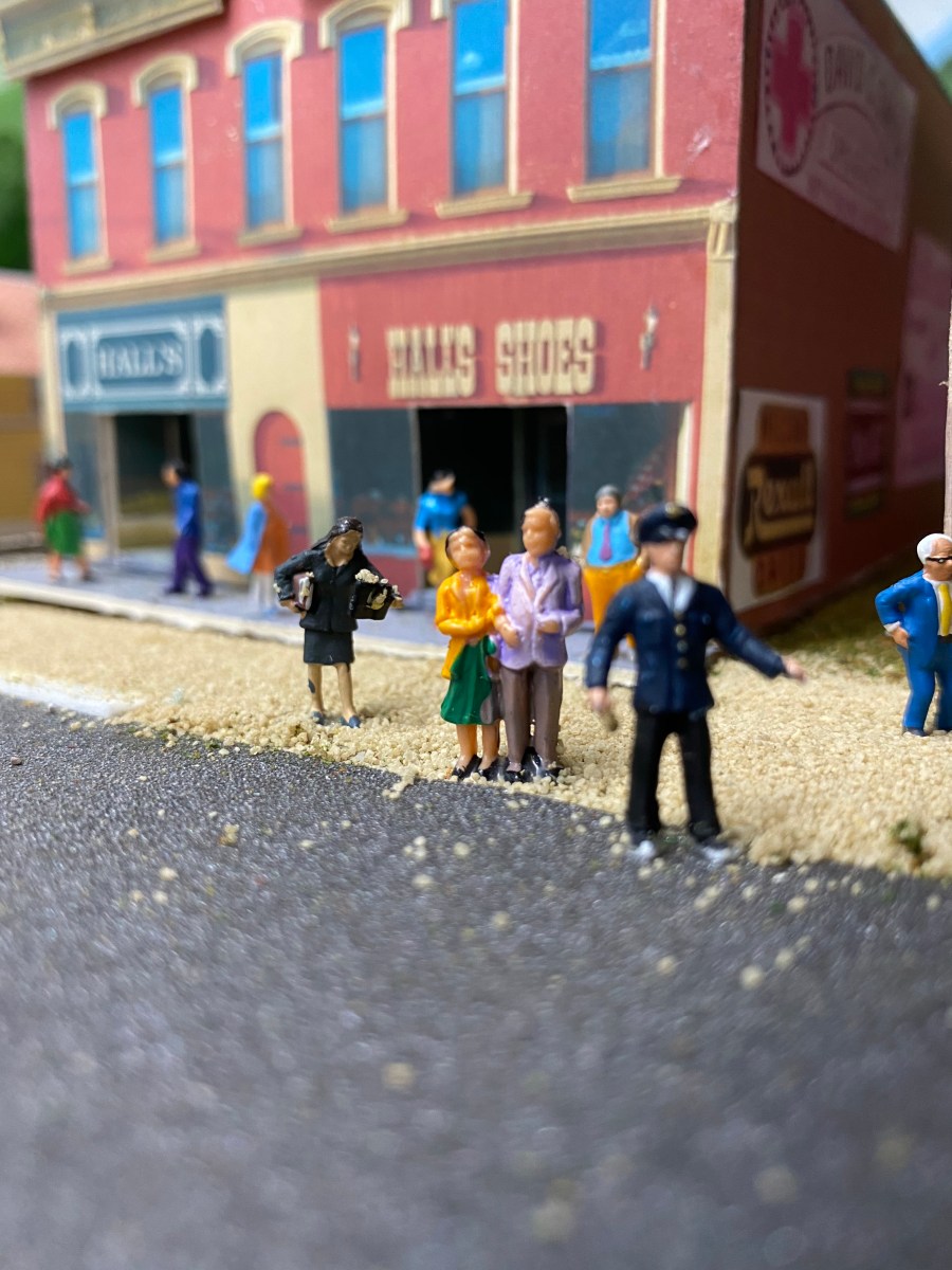 People standing in the street, talking.