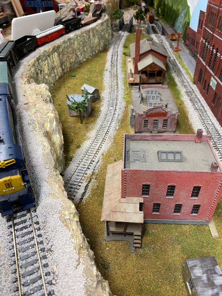 Mountain ridge, train, buildings, tracks, factory