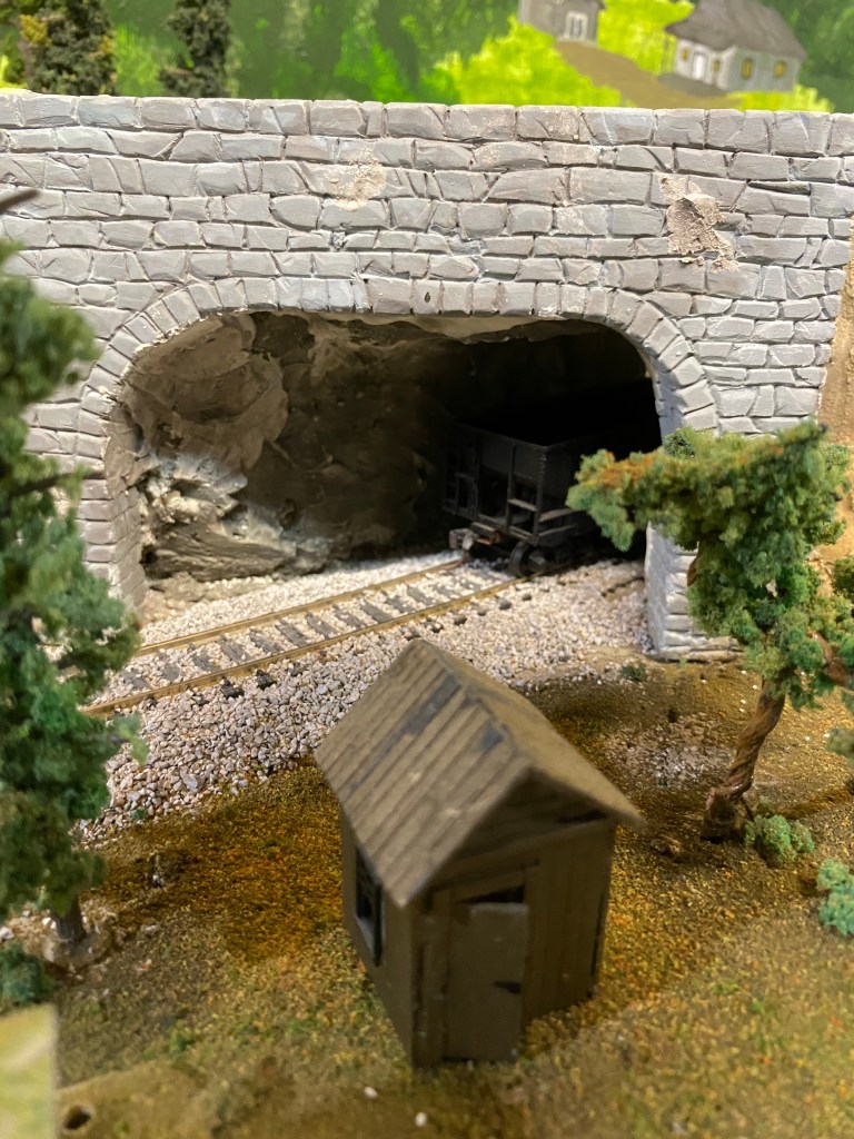 Shed, track, tunnel, trees, grass