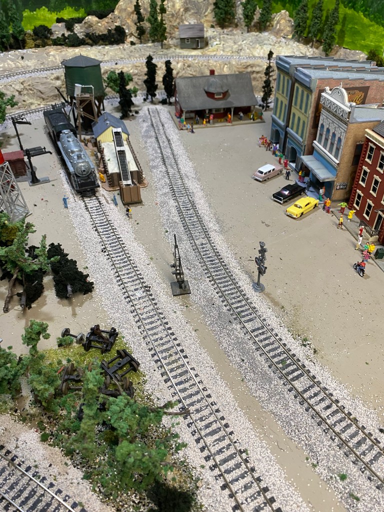 Two tracks in town, trees, buildings