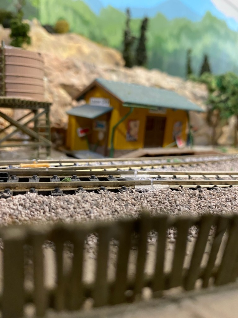 Fence, shed, tracks, water tank, trees