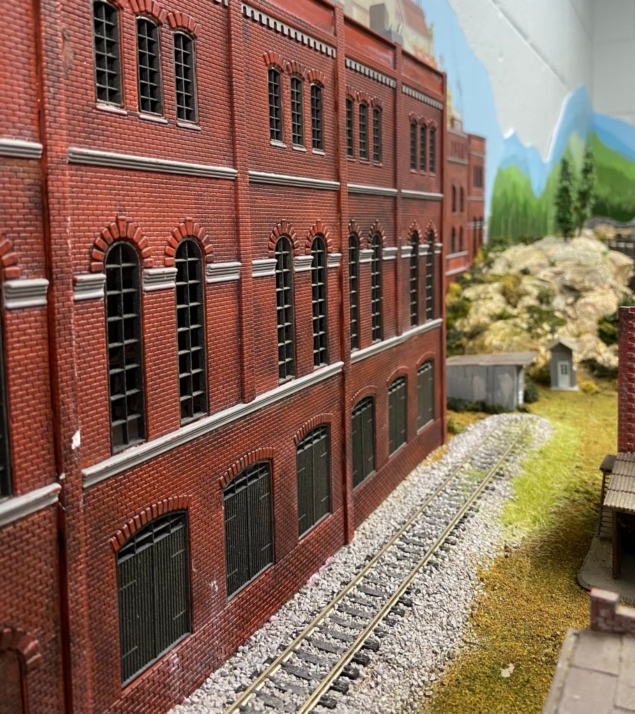 Building, track, factory, hills, trees