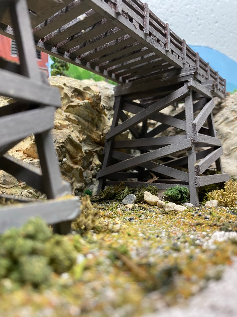 Bridge, towers, dirt, hills, rocks