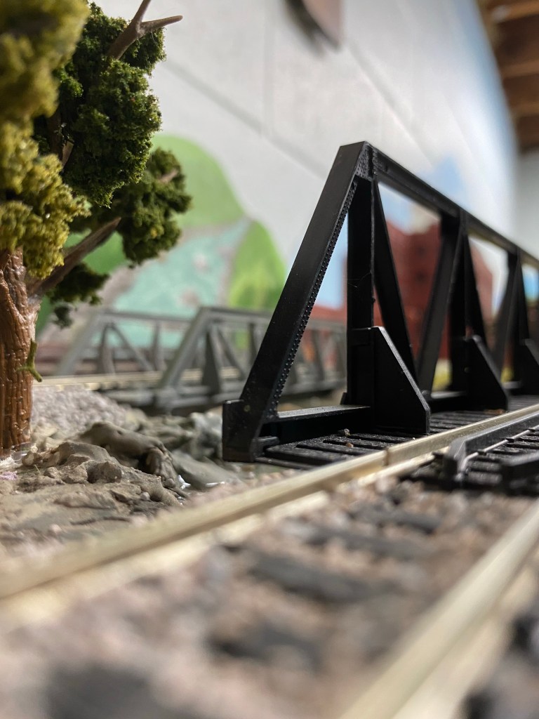 Tracks, tree, steel bridges, hills, river