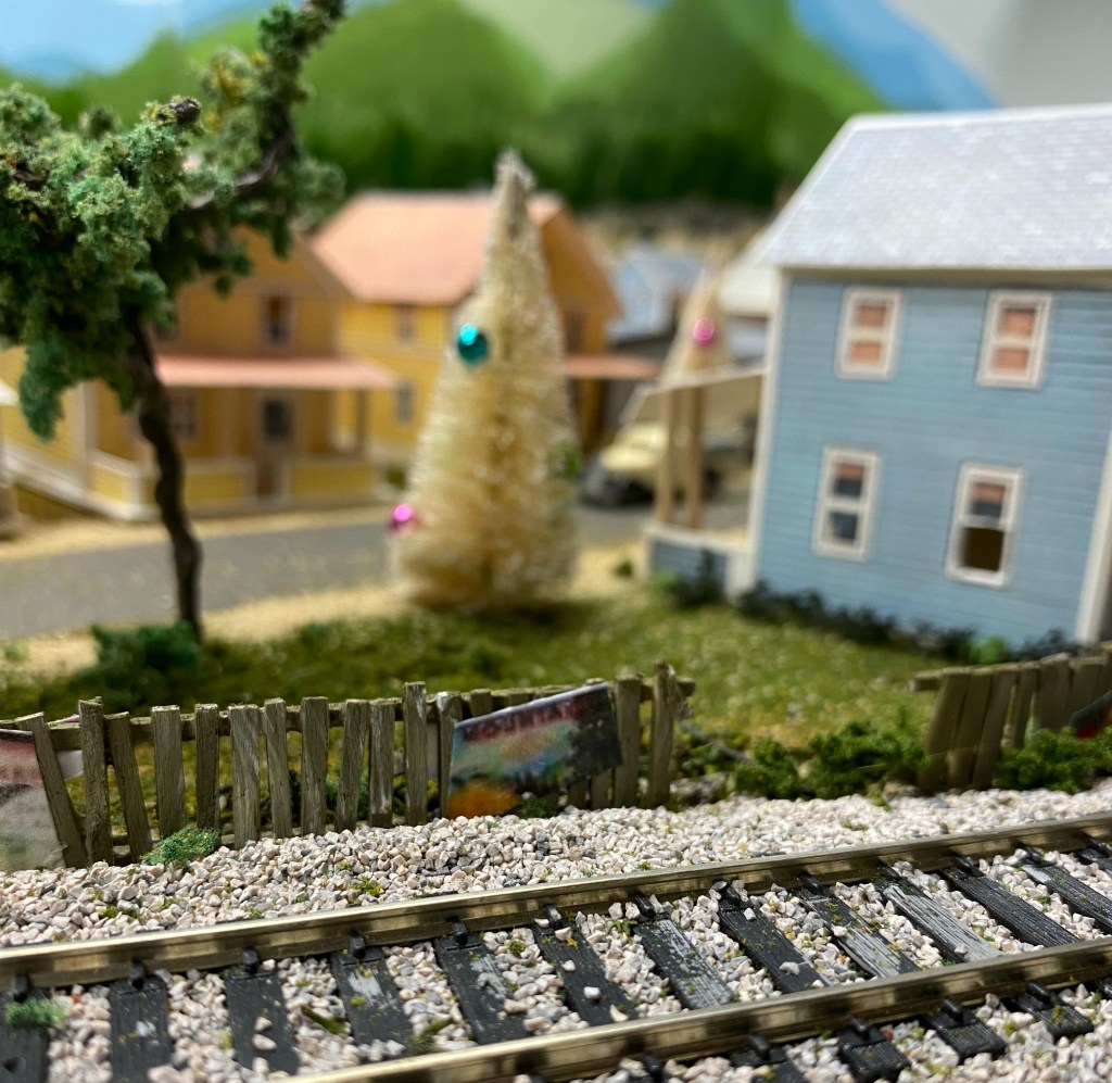 Track, fence, houses, trees, Christmas tree, people