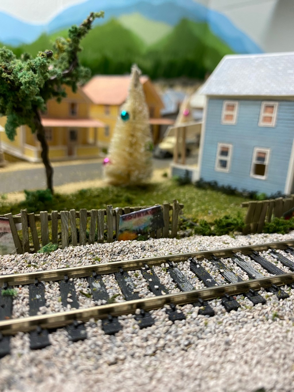 Track, fence, houses, trees, Christmas tree, people