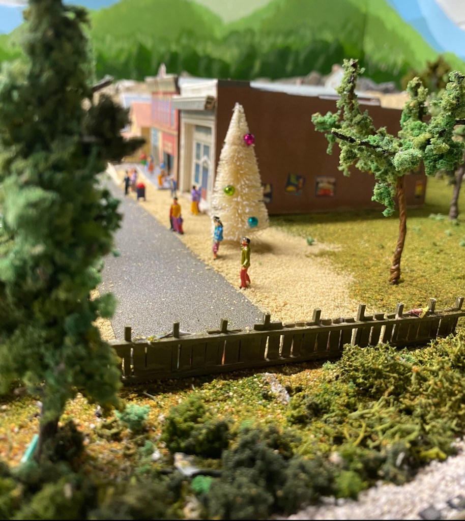 Bushes, trees, fence, buildings, people, track, Christmas tree