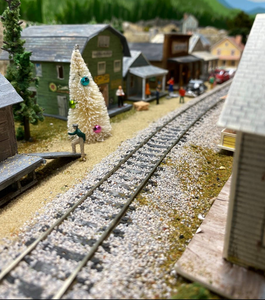 Track, buildings, street, people, Christmas tree