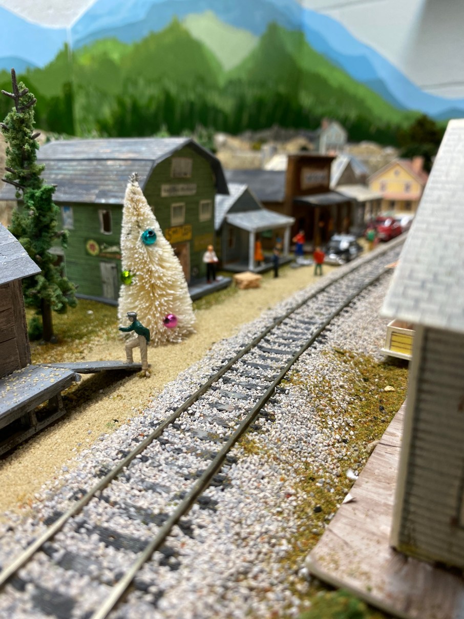 Track, buildings, street, people, Christmas tree