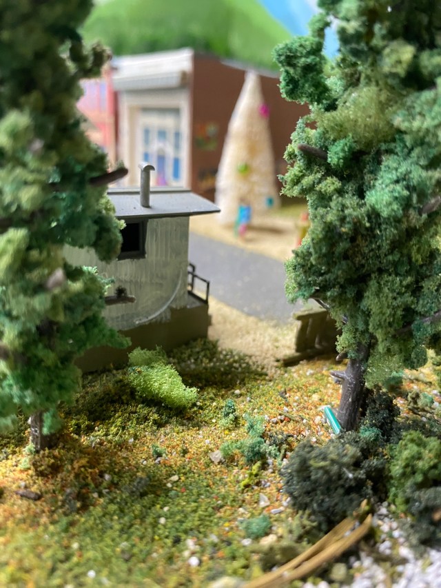 Trees, caboose, buildings, Christmas tree