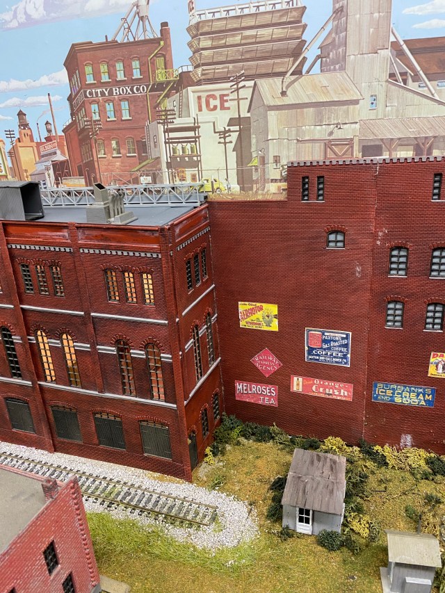 Small work sheds and loading track near Maple Valley Manufacturing with a small building in the foreground.