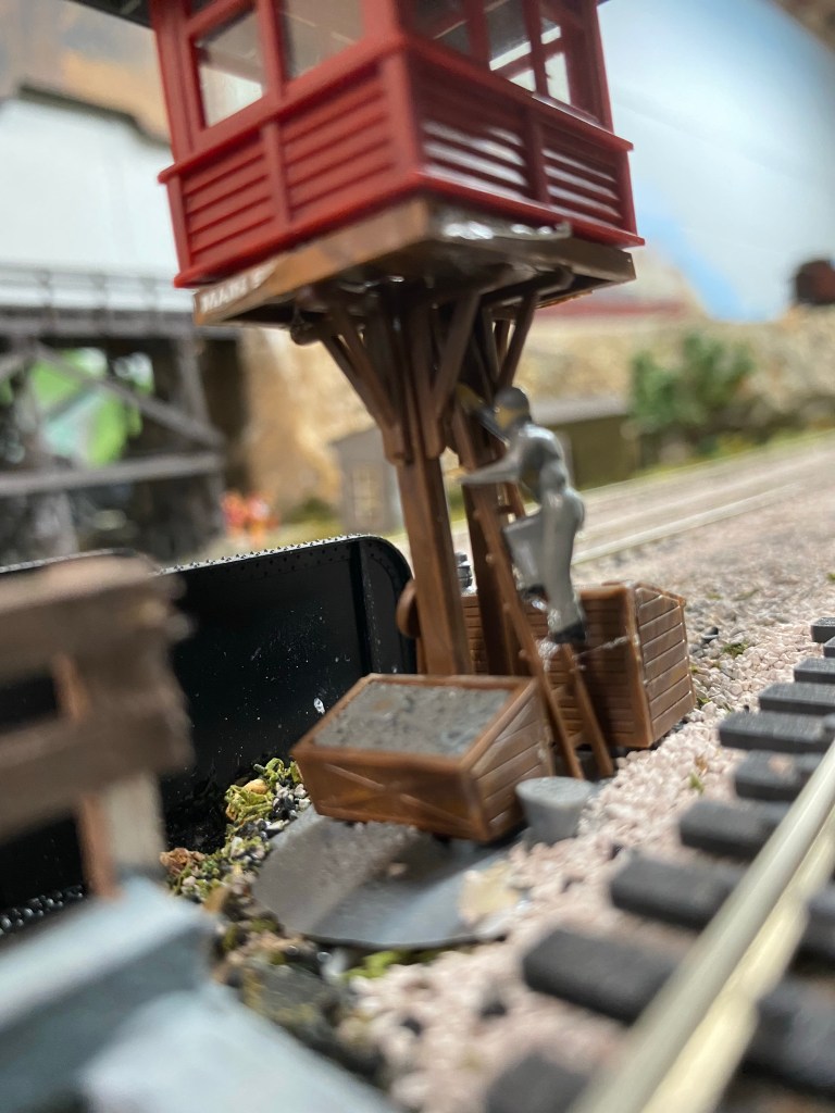 A man is climbing the ladder to the tower.