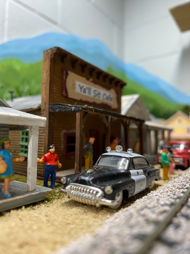 A sheriff patrol car is parked in front of the Ya'll Sit Cafe while questions are being asked about a shoplifter.
