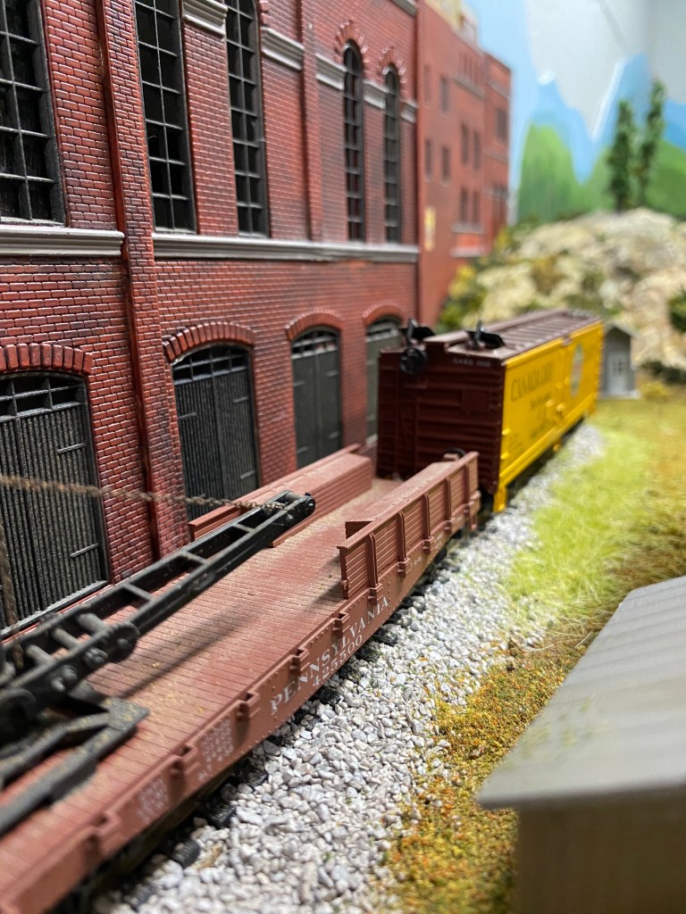 Two cars are sitting in front of the manufacturing plant near Maple Valley.