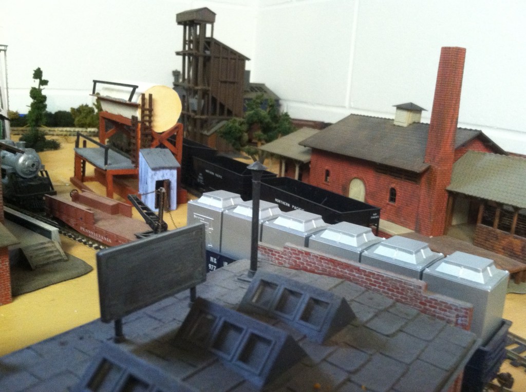 Factory buildings, train cars, trees