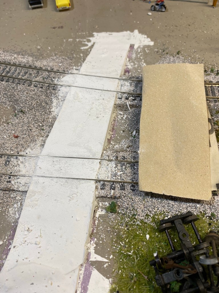A plaster grade crossing covering two tracks.