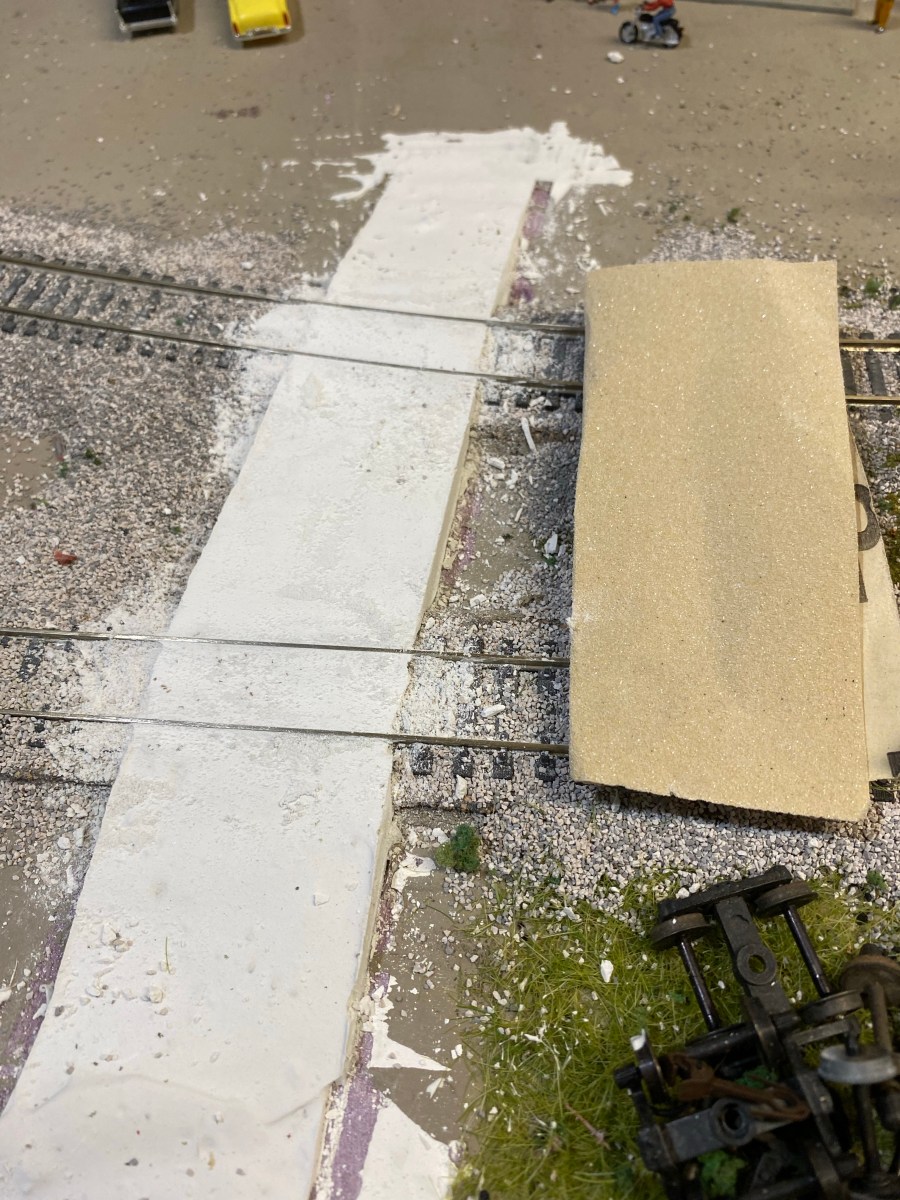 A plaster grade crossing covering two tracks.