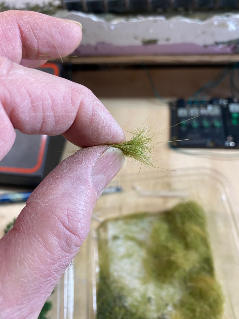 Example of Woodland Scenics grass ready to be planted, plastic container