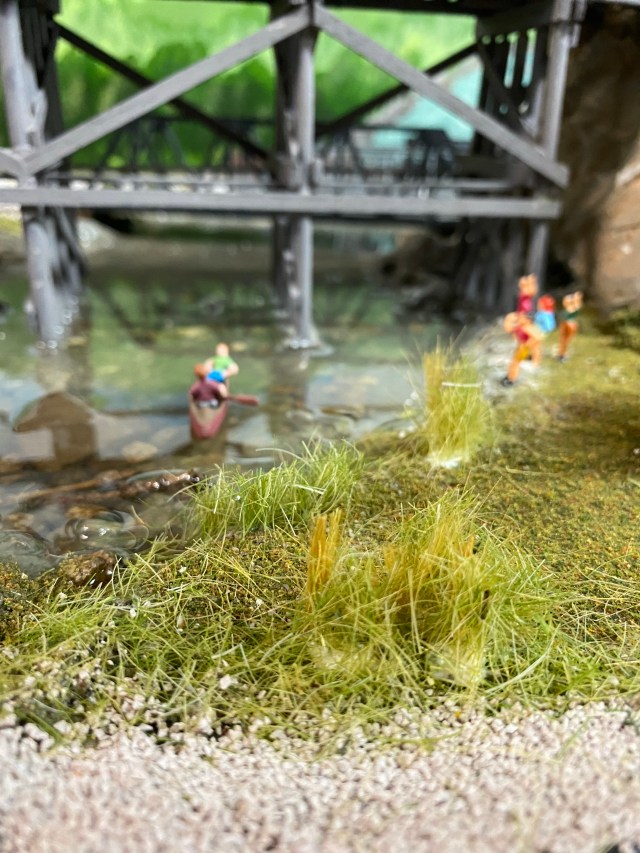 Woodland Scenics grass planted, swimmers, canoers, trestle bridge