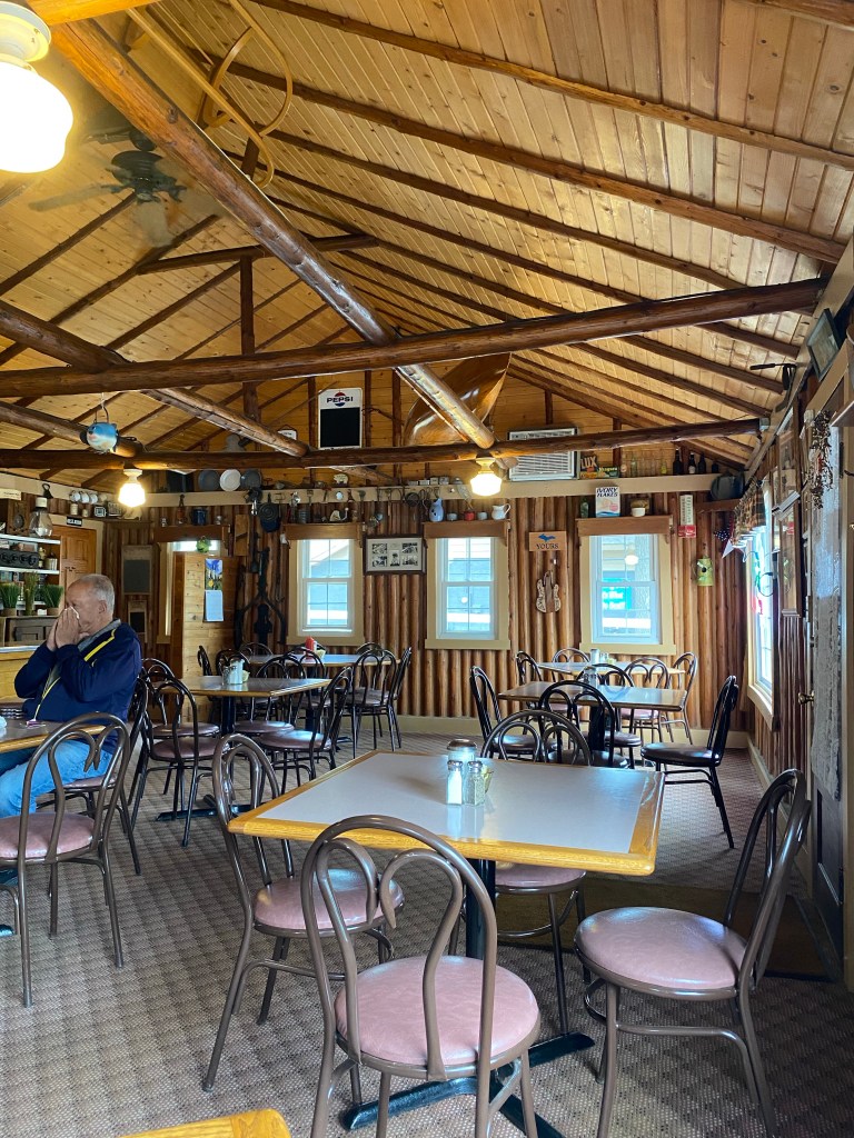 Log cabin interior, tables, chairs, windows, vintage decor, very attractive