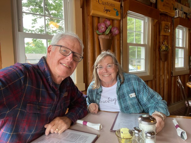 Dale & Mary Parsons, table, log wall, windows, cabin decor