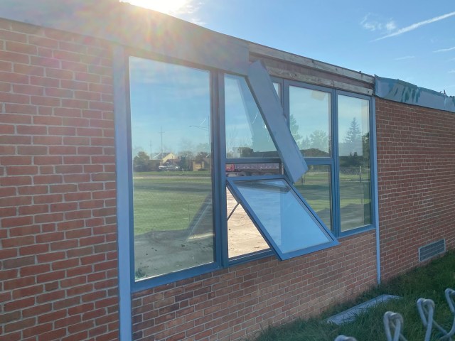Brick wall, windows, grass