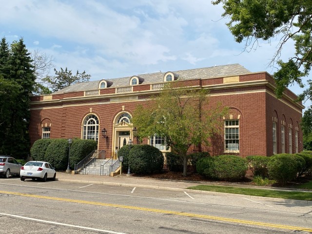 Brick building, windows, door, street, cars